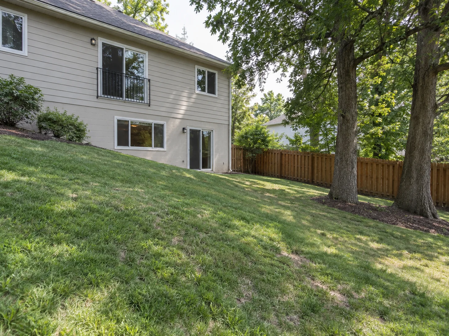 Raised Western Red Cedar Deck on a Sloped Backyard — Before