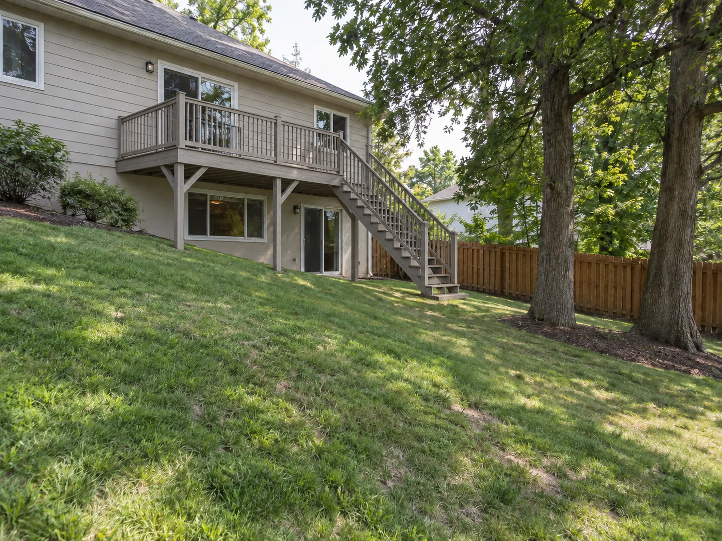 Raised Weathered Gray Wood Deck with Stairs — After