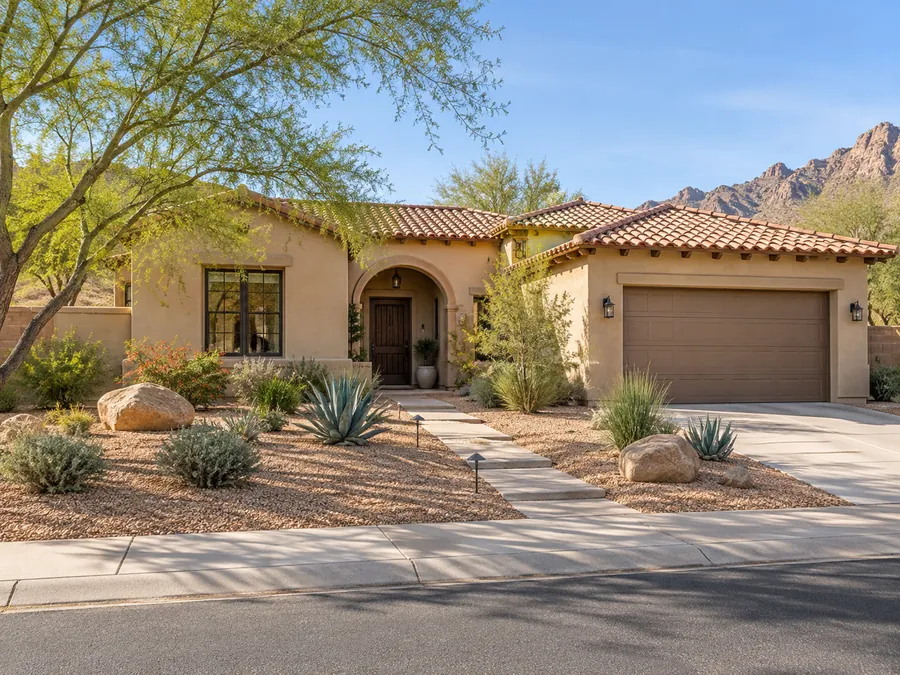 Illustrative AI concept: sand stucco Southwest ranch with decomposed granite, spaced agaves and a few substantial boulders give this stucco home a simple desert setting. A limited material palette keeps the design visually restrained.